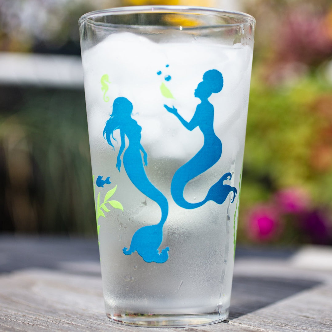 Two blue mermaids on an American-made pint glass