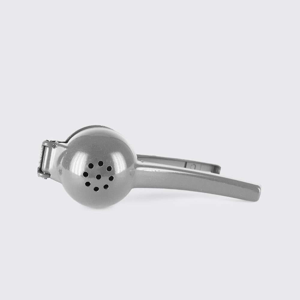 Metallic kitchen tool on a light gray background