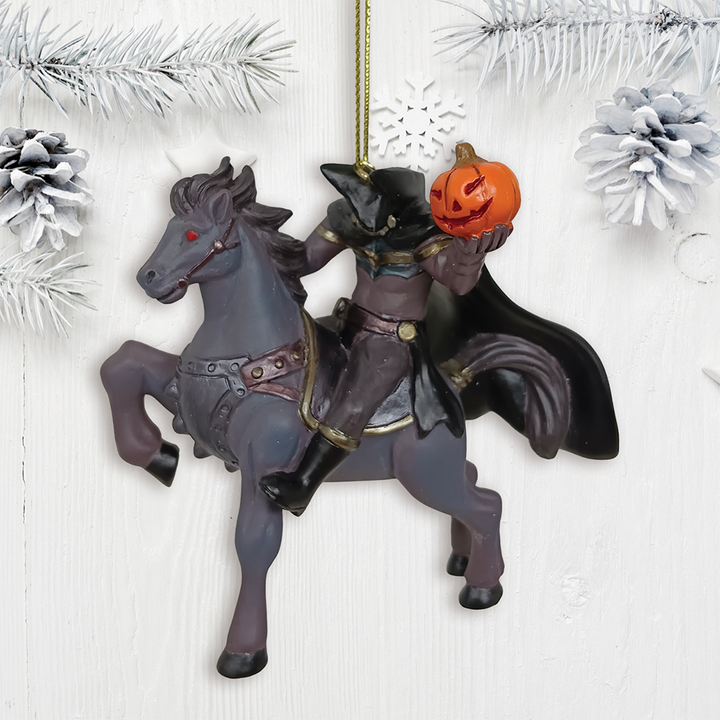Decorative ornament of a headless horseman riding a horse with a pumpkin, set against a white textured background.