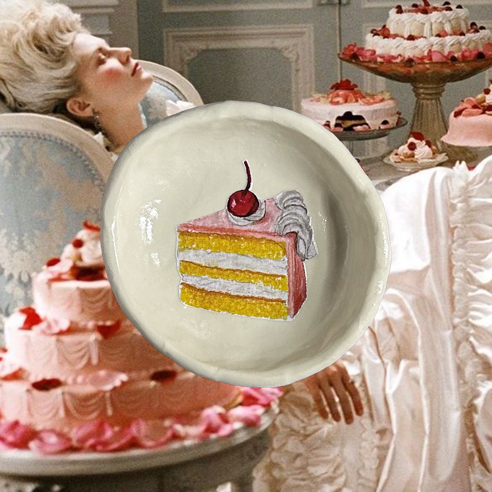 Decorative plate with a cake illustration on a film still of Kirsten Dunst as Marie Antoinette from Sophia Coppola's film