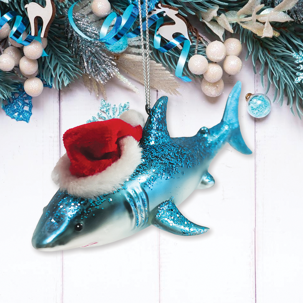Shark ornament with a red Santa hat on a Christmas tree background