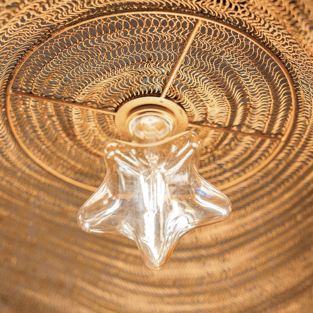 Star-shaped lightbulb in a ceiling lamp made of woven metal