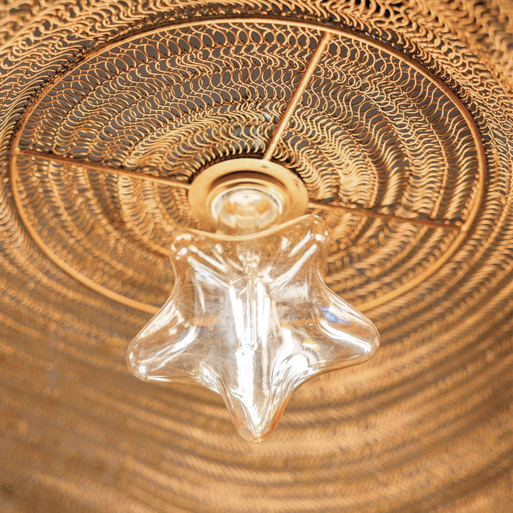 Star-shaped lightbulb in a ceiling lamp made of woven metal