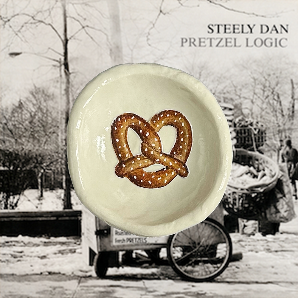 Steely Dan's Pretzel Logic album cover with a trinket dish featuring a pretzel illustration