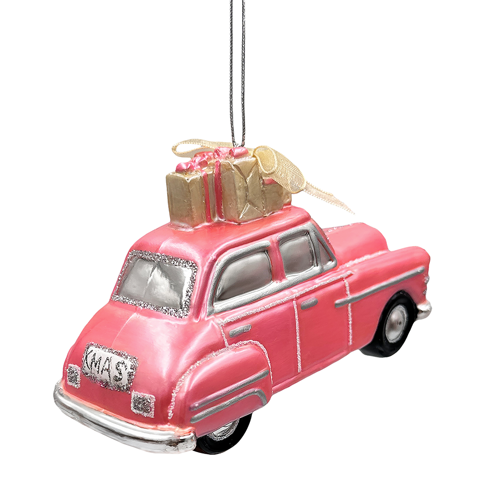 Pink vintage car ornament with a gold bow and gift on a white background
