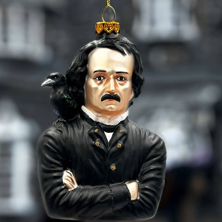 Decorative ornament of Edgar Allen Poe  with a raven on his shoulder against a blurred background.