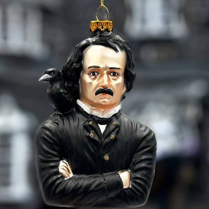 Decorative ornament of Edgar Allen Poe  with a raven on his shoulder against a blurred background.