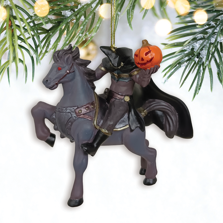 Halloween-themed ornament with witch riding a horse and pumpkin head, hanging from a tree.