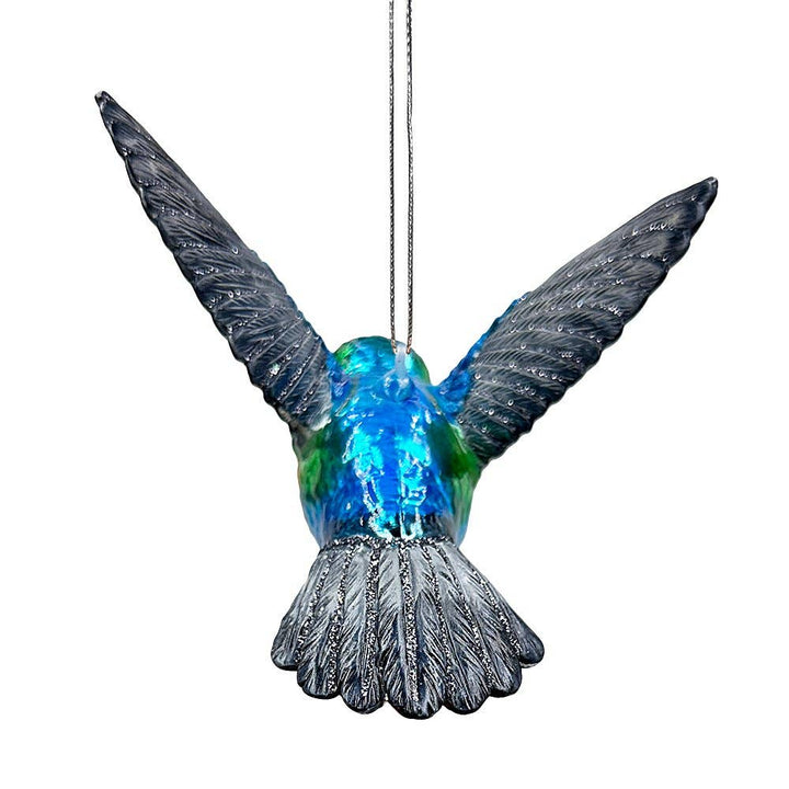 Decorative hummingbird ornament with blue and gray colors on a white background