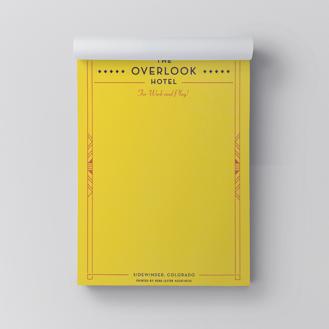 Yellow notepad with 'The Overlook Hotel' design on a gray background