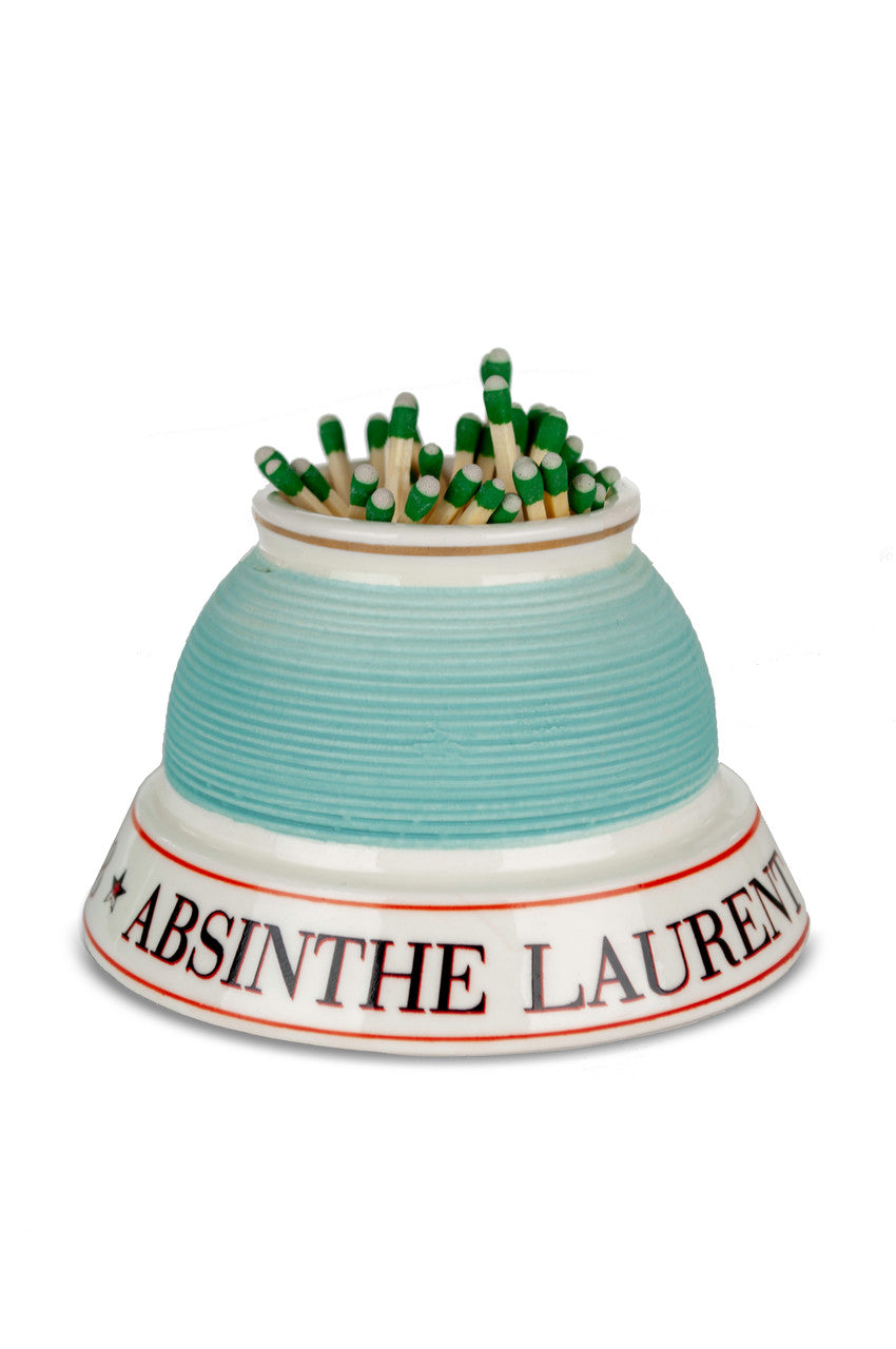 Ceramic match striker with green matches on a white background