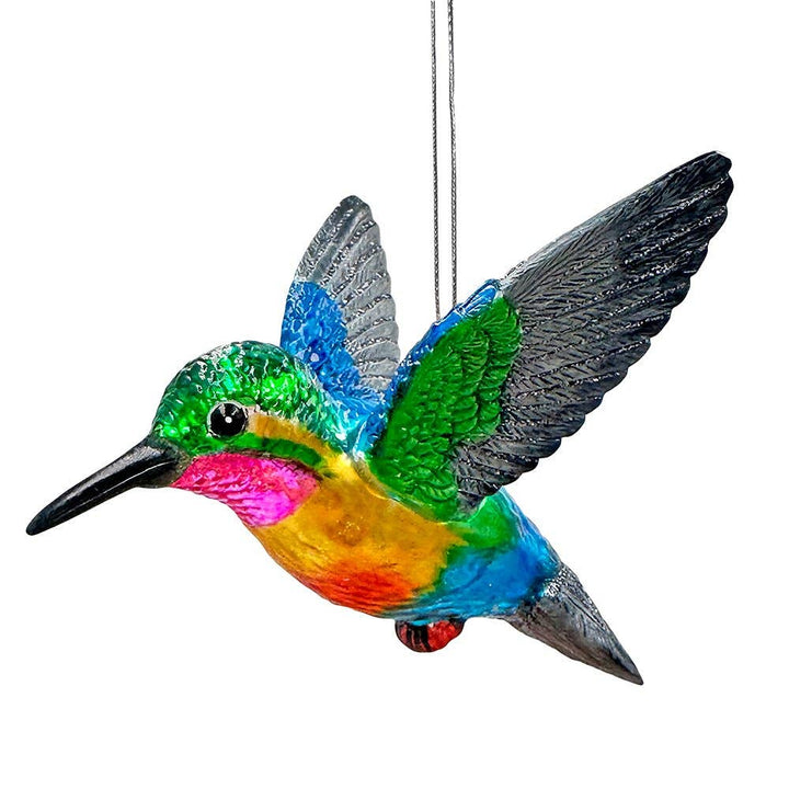 Colorful hummingbird ornament hanging against a white background