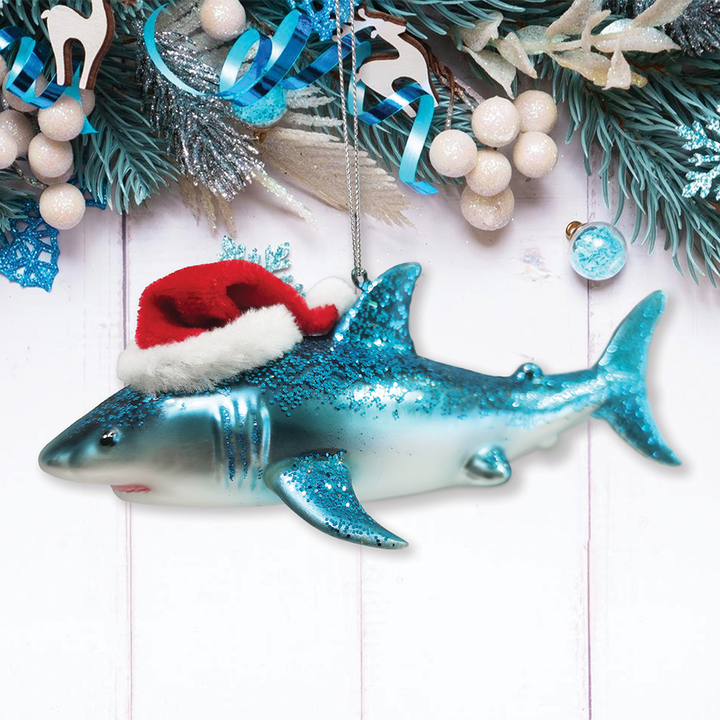 Shark ornament wearing a Santa hat on a Christmas-themed background