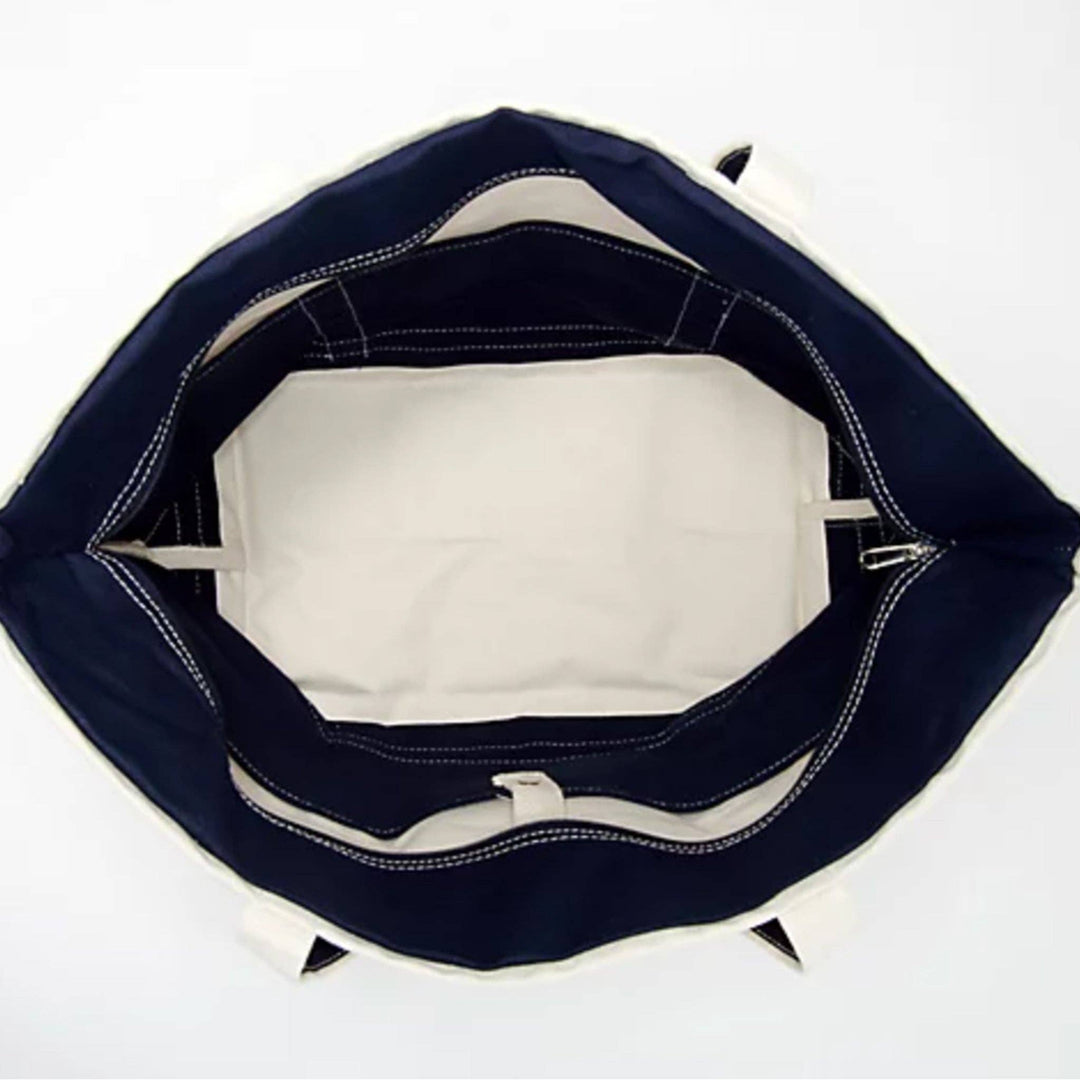 Inside view of a canvas tote bag with a zipper closure and inner pockets