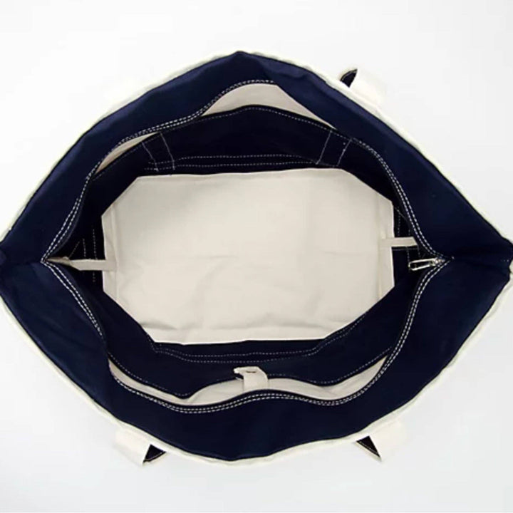 Inside view of a canvas tote bag with a zipper closure and inner pockets