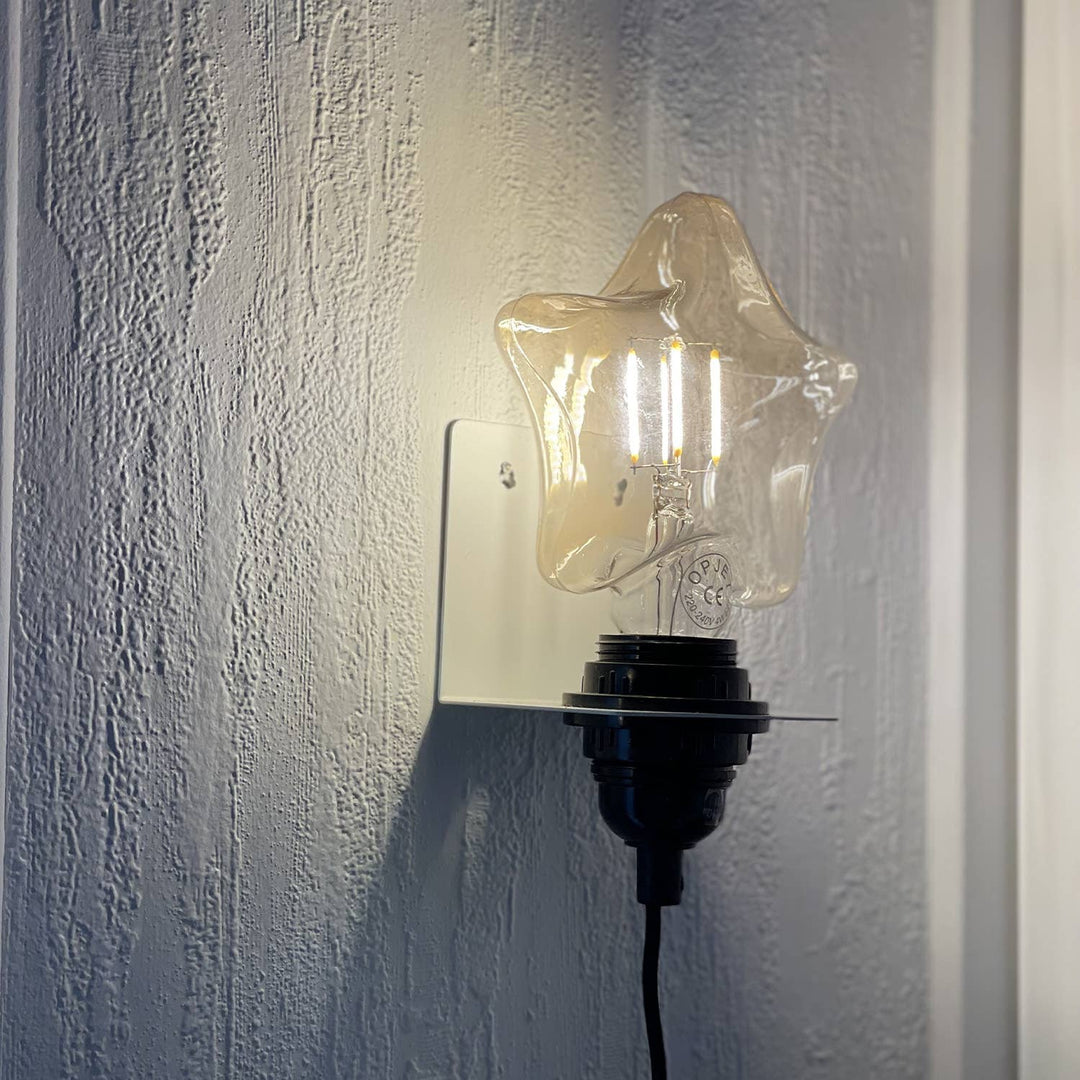 Star-shaped wall light fixture on a textured wall